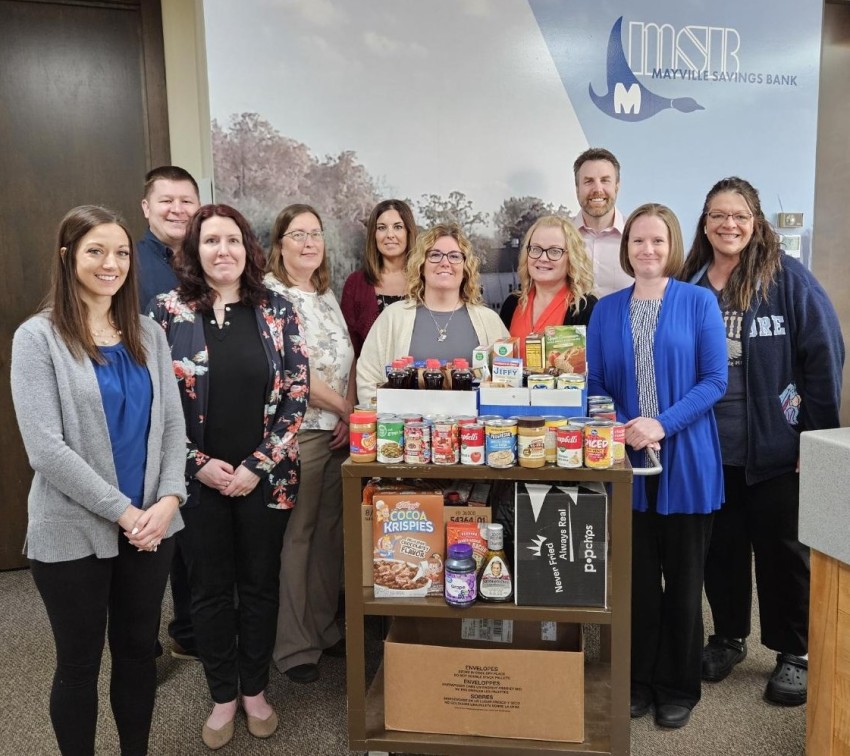 Bank staff with a rep from the food pantry with all of the donations.
